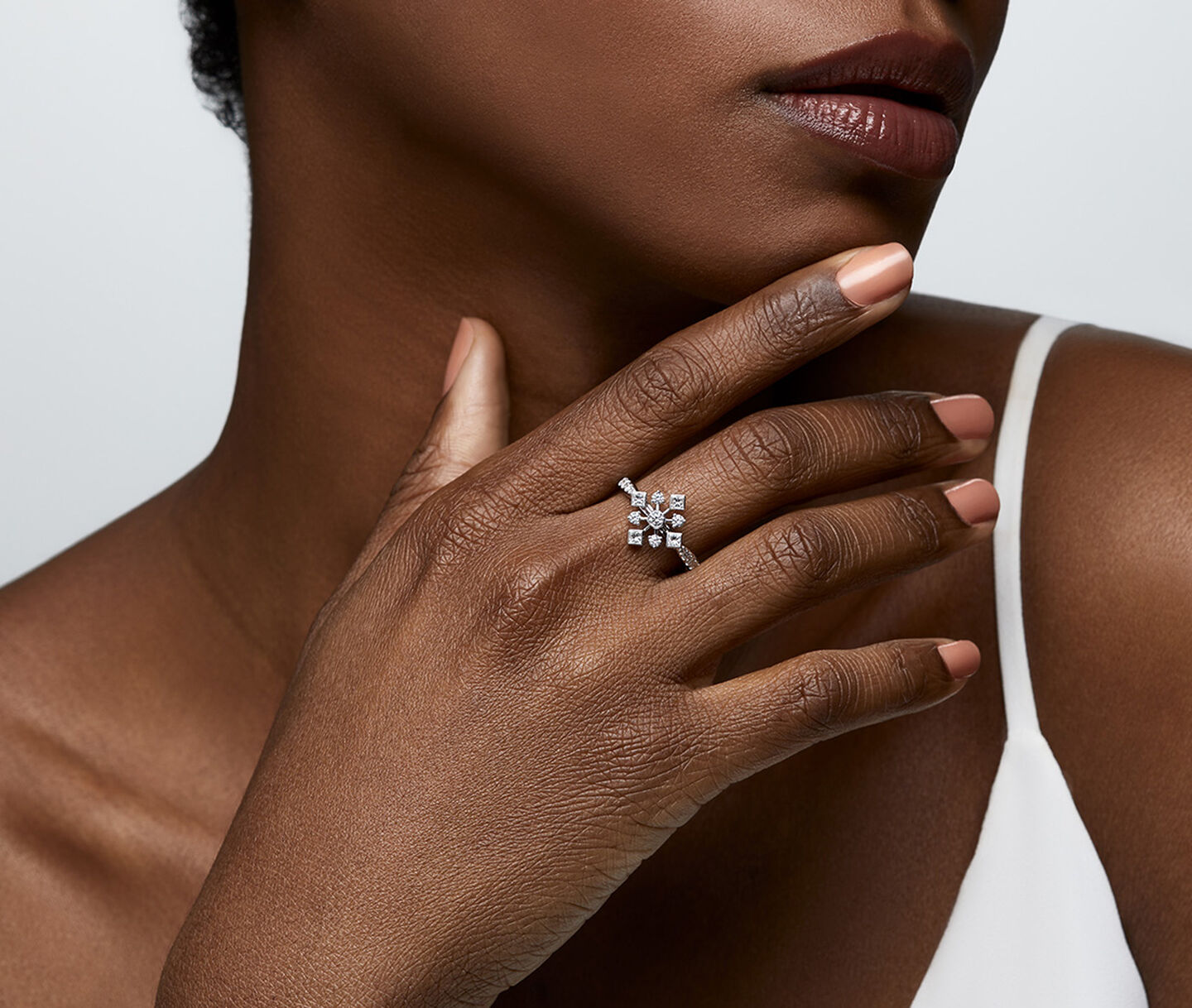 A woman wearing a Birks Snowflake diamond ring.